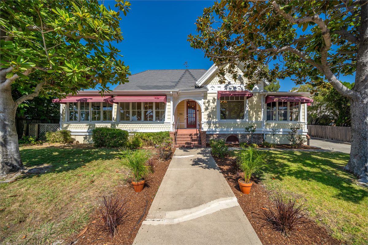 A tidy front lawn, fresh planting beds and a clear walkway leading to a classic home